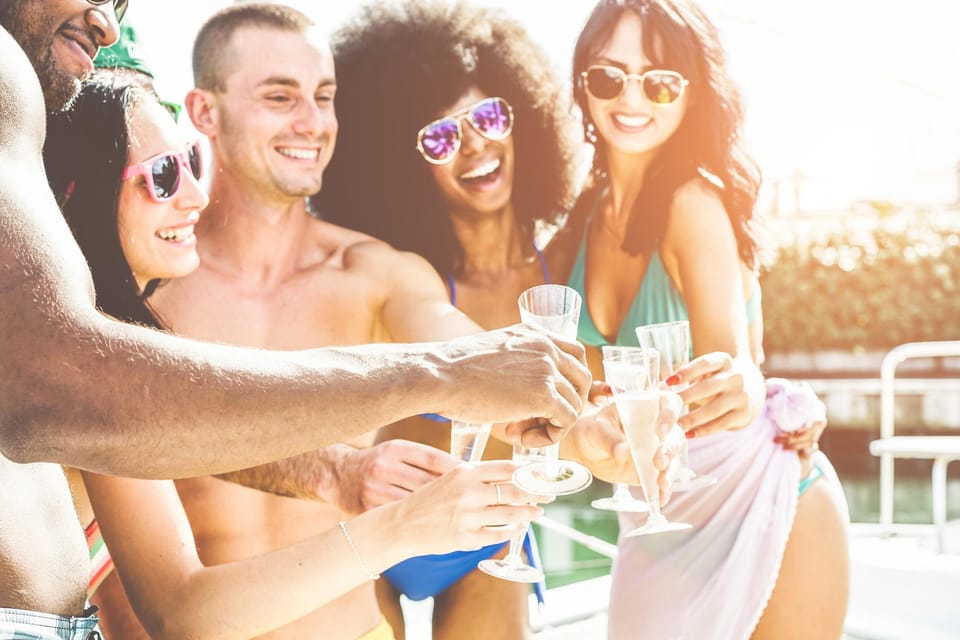 Boat Party to the Beach with Swimming Stops, DJ and Open Bar - Finding the Pacific Cruises booth at Praça do Comércio