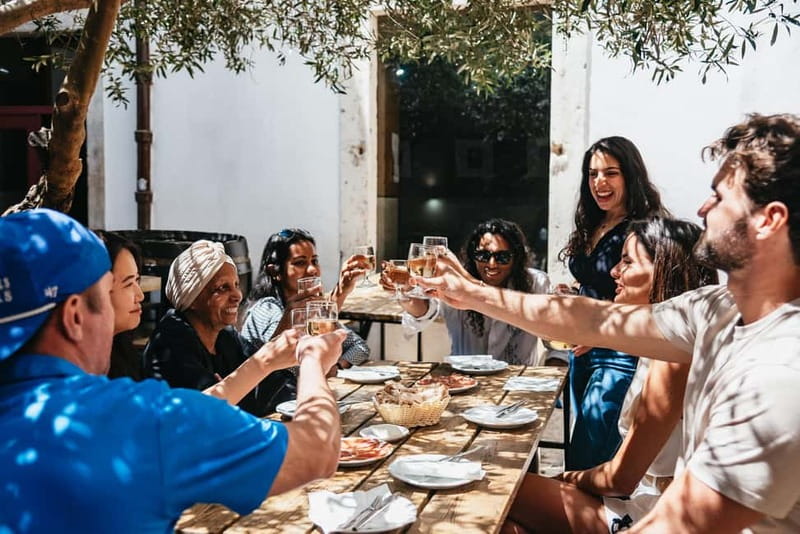 Lisbon: Baixa District Food Tour with Dinner and Drinks - Walking through Praça Dom Pedro IV and St. Dominic’s Square