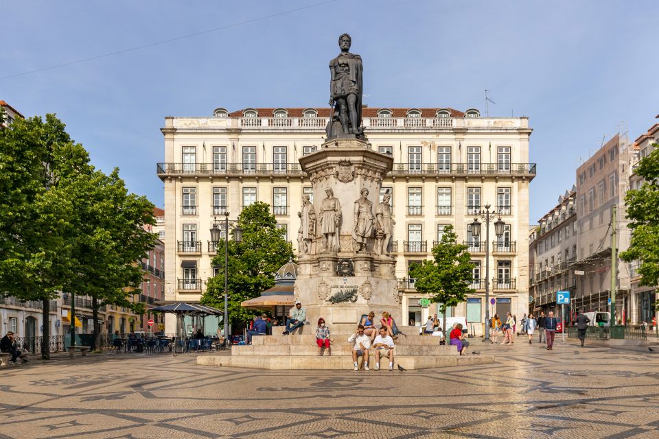 Lisbon: History, Stories and Lifestyle Walking Tour - Baixa connections and the tram ride up toward Portas do Sol